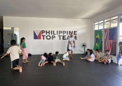Coach Armand Panganiban gathering the young students for a briefing before starting a Brazilian Jiu-Jitsu class at PHTT.