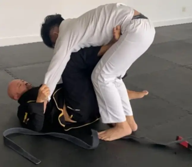 Instructor Armand Panganiban of Philippine Top Team demonstrating a technical grappling position against a male student.